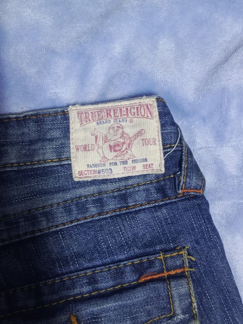 True Religion Section 503 Flared Jeans (Category: Jeans) located in City of Isabela. Submitted by warmbird.d06e6f (Listing ID 1470946031, Image 3). Description: - Brand: True Religion - Style: Flared leg cut with contrast paneling and mid-rise waist - Color: Dark blue wash - Pockets: Signature button-flap back pockets and front pockets with miniature watch pocket detail - Details: Classic Buddha brand patch on back waistband, RN 112790 tag inside