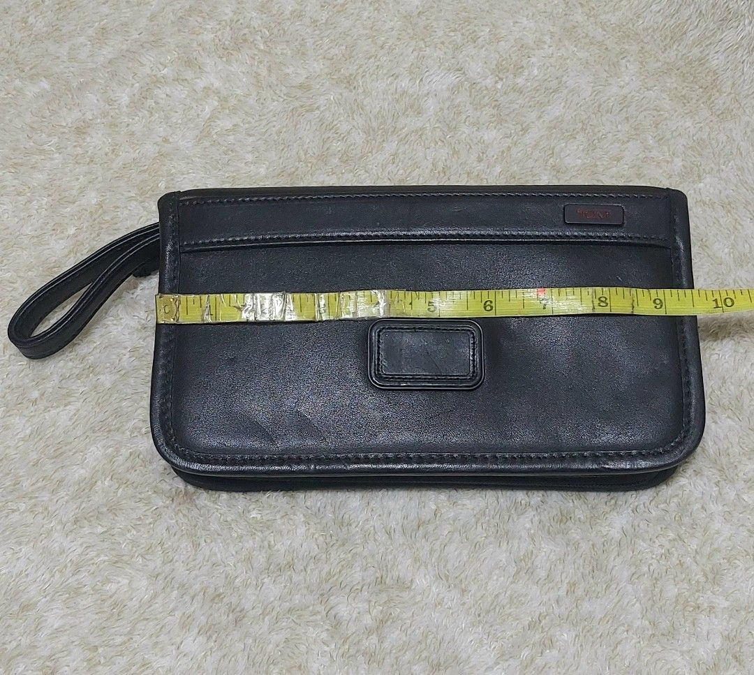 Tumi Leather Clutch Wrislet Bag (Category: Luxury Bags & Wallets) located in Davao. Submitted by wengbagstuff (Listing ID 1471081403, Image 3). Description: ✅️ no issues, in very good condition ✅️ no rubs, no open pipes ✅️ 💯✔️ - Features: Attached side wrist strap and secure zip closure - Interior: Fabric-lined with multiple card slots and zip compartments - with Tumi metal logo on front and Tumi tracer metal plate inside (Style 92113DH) - Condi