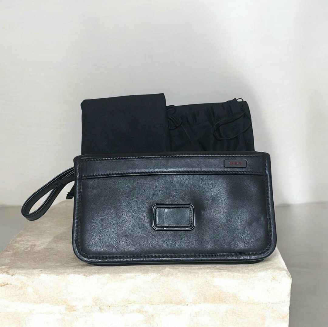 Tumi Leather Clutch Wrislet Bag (Category: Luxury Bags & Wallets) located in Davao. Submitted by wengbagstuff (Listing ID 1471081403, Image 1). Description: ✅️ no issues, in very good condition ✅️ no rubs, no open pipes ✅️ 💯✔️ - Features: Attached side wrist strap and secure zip closure - Interior: Fabric-lined with multiple card slots and zip compartments - with Tumi metal logo on front and Tumi tracer metal plate inside (Style 92113DH) - Condi