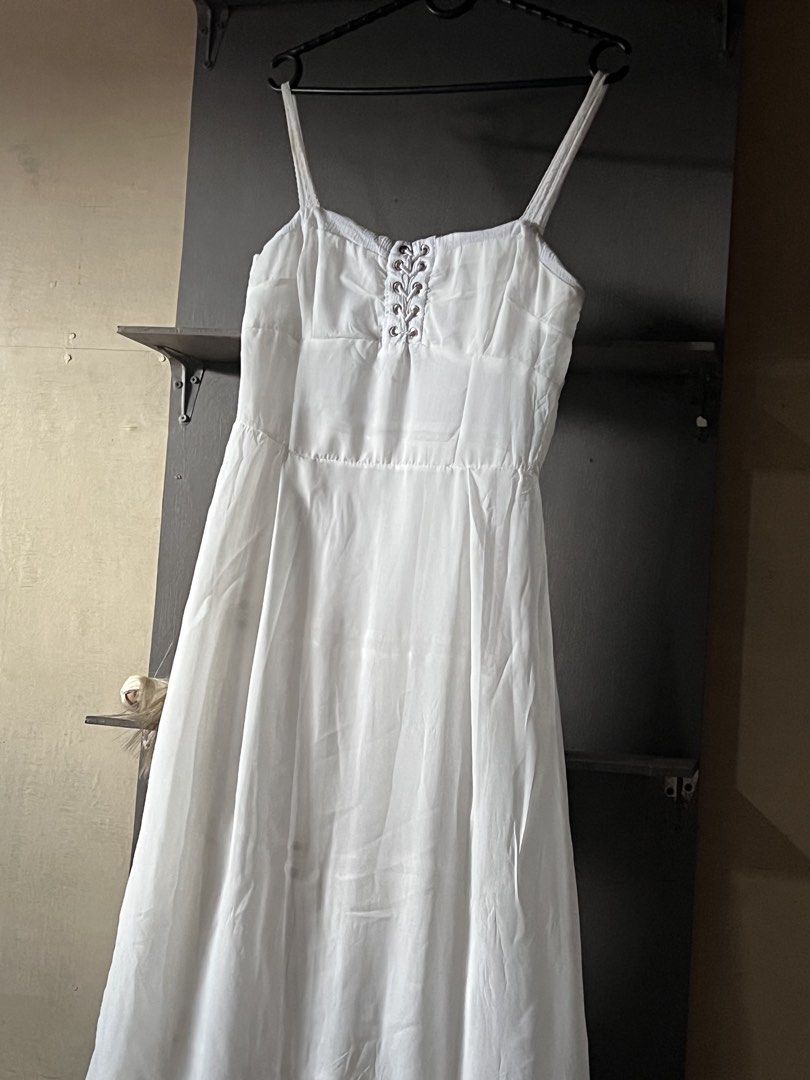 Two way white dress (Category: Dresses) located in Tagum. Submitted by midolli (Listing ID 1471018445, Image 2). Description: - Style: White maxi dress with a flowing - Texture: Crinkled fabric with thin spaghetti straps - Condition: Has a few minor yellowish stains on the lower front skirt area (ready for a quick wash or DIY fix).