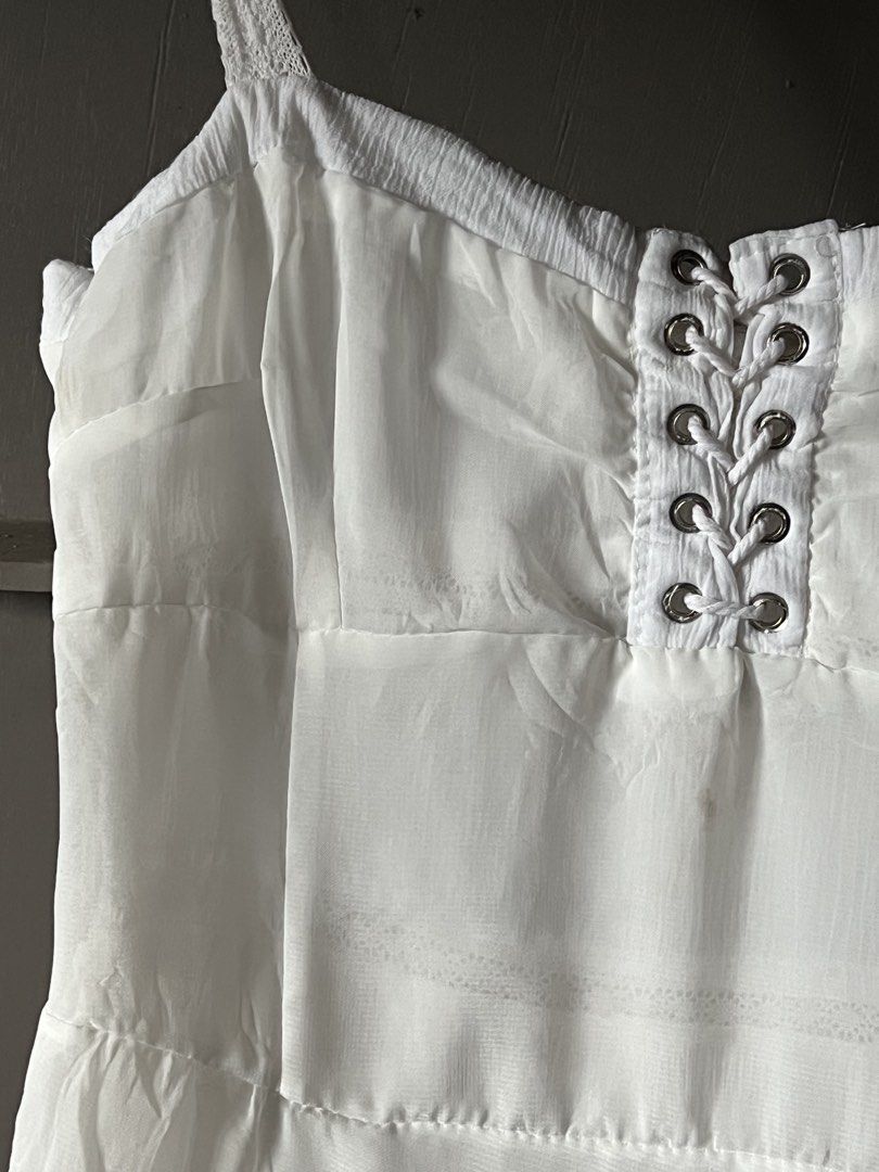 Two way white dress (Category: Dresses) located in Tagum. Submitted by midolli (Listing ID 1471018445, Image 3). Description: - Style: White maxi dress with a flowing - Texture: Crinkled fabric with thin spaghetti straps - Condition: Has a few minor yellowish stains on the lower front skirt area (ready for a quick wash or DIY fix).
