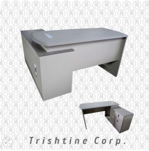 TXT-077 | Modern Executive L-type Table (Category: Office Furniture & Fixtures) located in Caloocan City. Submitted by jim.trishtineofficefurnitures (Listing ID 1471003463, Image 1). Description: - Modern executive desk in a sleek gray finish - Smooth curved top design for a comfortable workspace - Attached side cabinet with built-in drawers and open shelving for extra storage - Sturdy and durable build with clean lines - Versatile style that eas