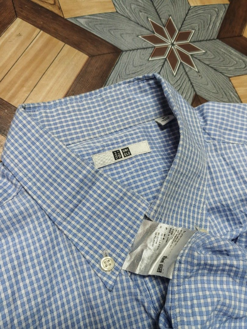 Uniqlo Blue Gingham Check Short Sleeve Button Down Shirt (Category: Tshirts & Polo Shirts ) located in General Santos City (Dadiangas). Submitted by reloom_archives (Listing ID 1471035108, Image 2). Description: - Brand: Uniqlo - Style: Short sleeve shirt in a classic blue gingham check pattern - Size: M - Features: Button-down collar, front button closure, and single left chest pocket - Material: 88% cotton, 12% polyester blend - Condition: Clea