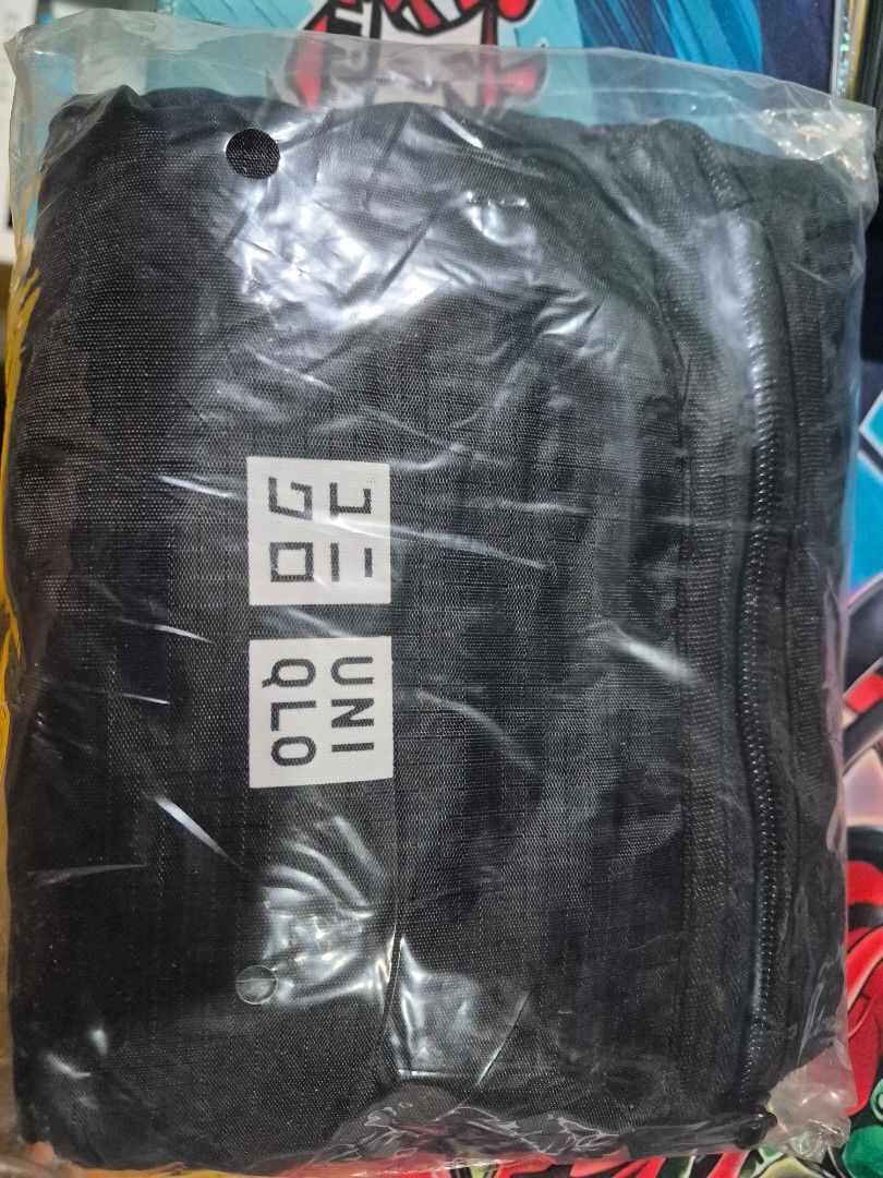 Uniqlo Duffle Bag (Category: Sling Bags) located in Quezon City. Submitted by gamerguy1211 (Listing ID 1471063151, Image 1). Description: - Brand: Uniqlo - Color: Black with white logo - Closure: Top zip - Material: Lightweight fabric - Condition: Brand new, unopened, and unused in original plastic packaging.