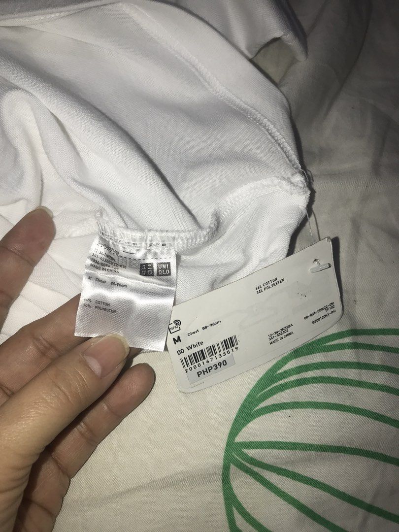 Uniqlo White T-Shirt Size M (Category: Tshirts & Polo Shirts ) located in Pasig City. Submitted by papotzy (Listing ID 1471088862, Image 3). Description: - Brand: Uniqlo - Color: White - Style: Crew neck t-shirt - Size: M (fits chest 88-96 cm) - Material: 66% cotton, 34% polyester - Condition: Brand new with original tags attached - Flaw: Has a faint faded graphic or stain mark across the chest area With stain.