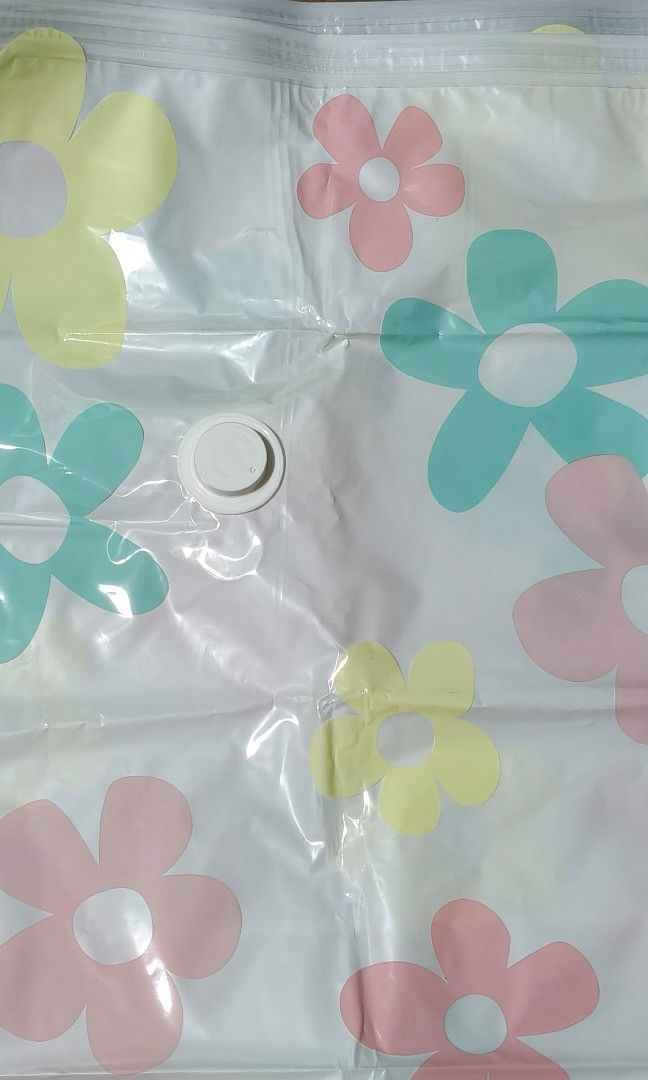 Vacuum Storage Bag for Clothes (Category: Bedding & Towels) located in Quezon City. Submitted by morningstar_52 (Listing ID 1471035539, Image 2). Description: - Cute floral design with pink, yellow, and turquoise flowers - Saves up to 80% closet space for winter coats, duvets, and blankets - Secure zip top closure keeps items protected - Convenient white air valve on the top left for easy vacuum sealing - Made of clear plastic so you can easily s