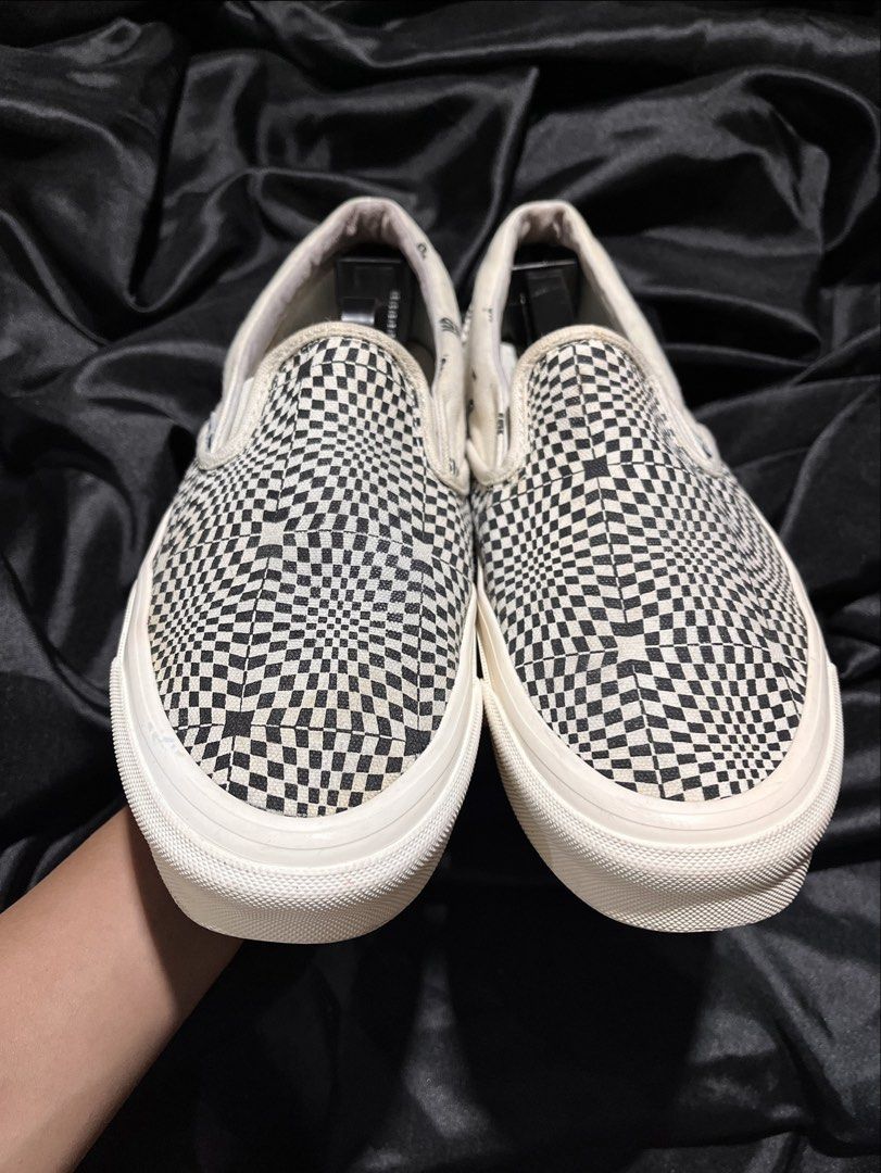 Vans Checkerboard Optical Illusion Slip-On Vault (Category: Sneakers) located in Consolacion. Submitted by archerowar_20 (Listing ID 1471093959, Image 2). Description: Vans slip-on sneakers with black and white optical illusion checkerboard pattern all over the canvas upper. Classic off-white vulcanized rubber midsole and waffle gum rubber outsoles. 'Off The Wall Originals' red branding on the heels. Slip-on design with elastic side accents. Clea