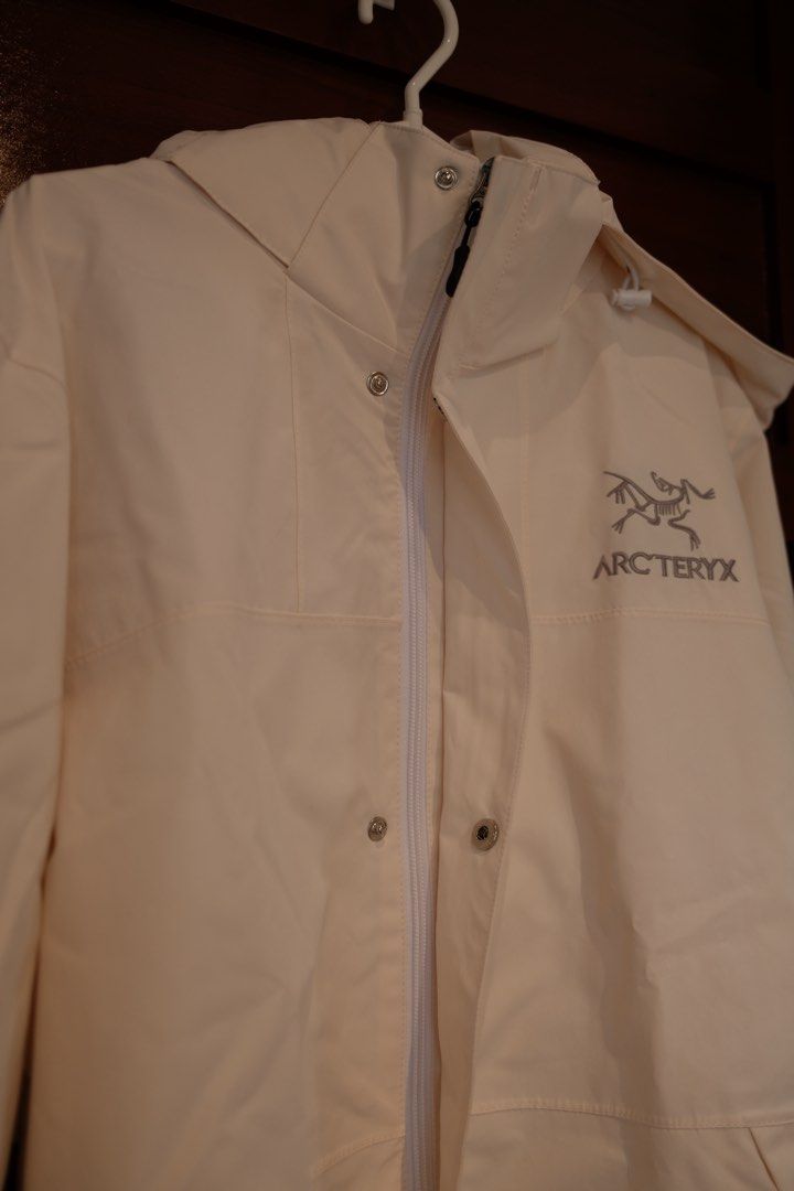 Vietnam Arc'teryx Hooded Jacket (Category: Coats, Jackets and Outerwear) located in Makati City. Submitted by nomoreclutterph (Listing ID 1471038711, Image 2). Description: - Arc'teryx bought in Vietnam - Color: Off-white - Size: Large - Attached hood with adjustable drawstrings - Front zipper closure with snap-button storm flap - Iconic embroidered Arc'teryx logo on chest and back shoulder - Clean, minimalist aesthetic, perfect as a solid outdoo