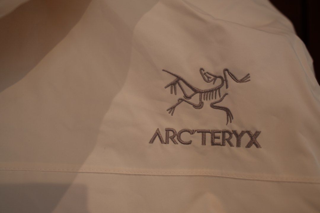 Vietnam Arc'teryx Hooded Jacket (Category: Coats, Jackets and Outerwear) located in Makati City. Submitted by nomoreclutterph (Listing ID 1471038711, Image 3). Description: - Arc'teryx bought in Vietnam - Color: Off-white - Size: Large - Attached hood with adjustable drawstrings - Front zipper closure with snap-button storm flap - Iconic embroidered Arc'teryx logo on chest and back shoulder - Clean, minimalist aesthetic, perfect as a solid outdoo