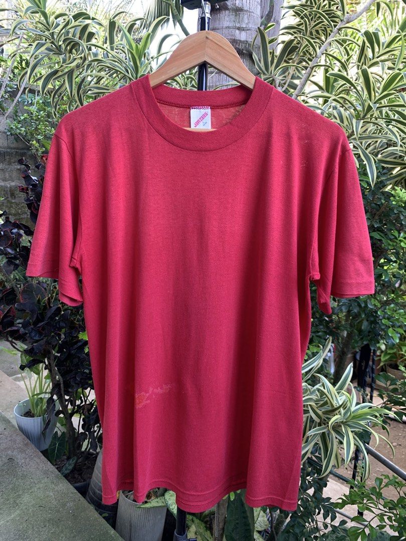 Vintage 1980s Jerzees blank tee (Category: Tshirts & Polo Shirts ) located in Cagayan de Oro. Submitted by premium_thrifts (Listing ID 1471030096, Image 1). Description: Red colorway. Good condition. Single stitch on sleeves and double on hem Fits Large L26.8" x W21" 18" (shoulder to shoulder) 8.5" (sleeve length) Issue: has fades, bleach stain spots, small holes on both armpit, and lints Add shipping fee (via JRS or J&T).