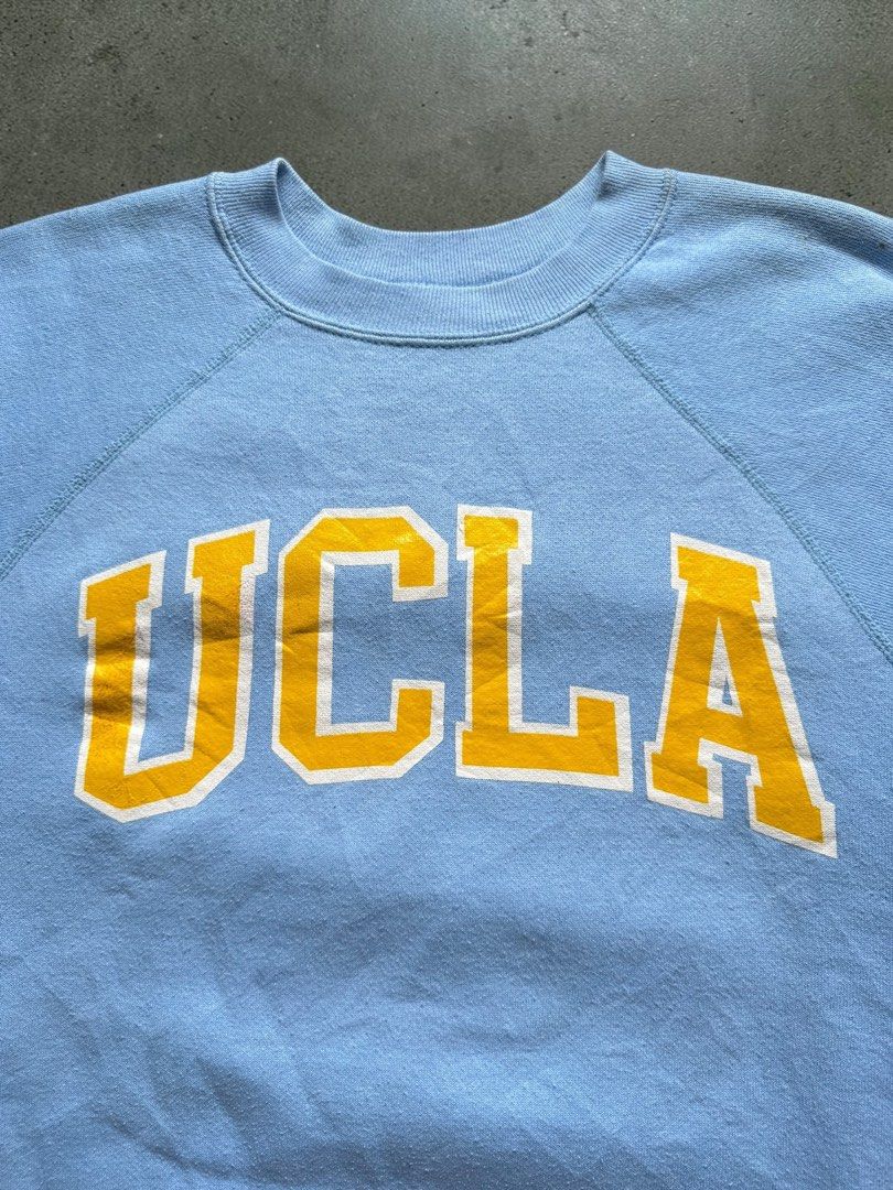 Vintage 1980’s UCLA Sweater (Category: Coats, Jackets and Outerwear) located in Pasig City. Submitted by hoardwrld (Listing ID 1470993459, Image 2). Description: Width: 24 Length: 27.5 - Brand/Style: Vintage Discus Athletic crewneck sweatshirt - Design: UCLA collegiate graphic in yellow with white outline - Color: Light blue heather with raglan sleeves - Details: Ribbed collar, cuffs, hem, and classic green woven tag - Origin: Made in USA - Size: