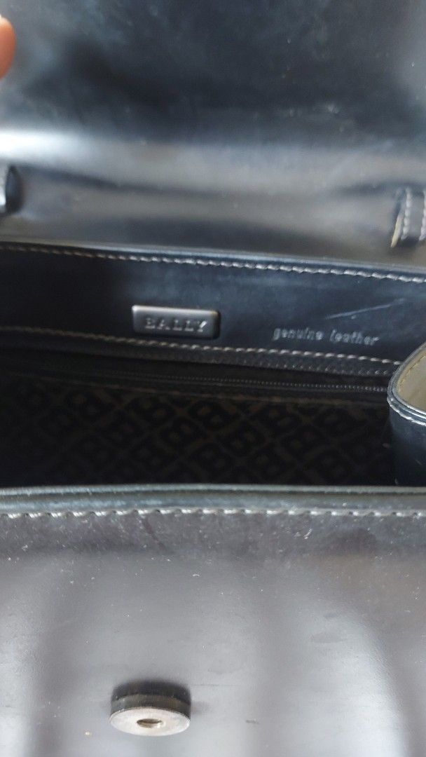 Vintage Bally Black Leather Bag (Category: Luxury Bags & Wallets) located in Cavite. Submitted by bonita2230 (Listing ID 1470957610, Image 3). Description: - Brand: Authentic Vintage Bally - Material: Black genuine leather with monogram fabric lining - Design: Structured shape, front flap closure with signature 'B' metal clasp - Features: internal zippered pocket, and 'genuine leather' stamp - Condition: Pre-loved with visible scuffs and surface 