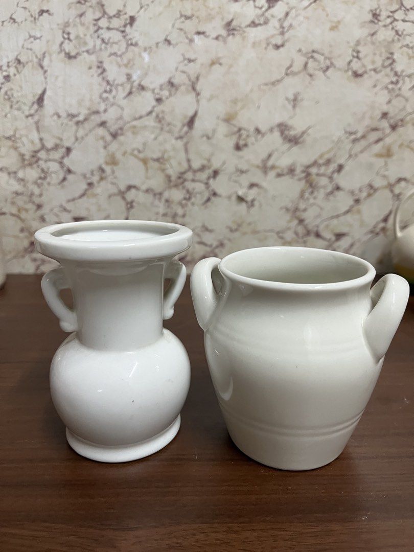 Vintage Ceramic Vases Pair with Handles and Floral Pattern (Category: Vases & Decorative Bowls) located in Manila. Submitted by kayerrr.gem (Listing ID 1471046468, Image 3). Description: - Set of 2 vintage white glazed ceramic vases with double side handles - Vase 1: Features elegant gold Japanese lettering and telephone number print - Vase 2: Decorated with a vibrant basket and flower pattern near the base, plus yellow and orange top rim trim - 
