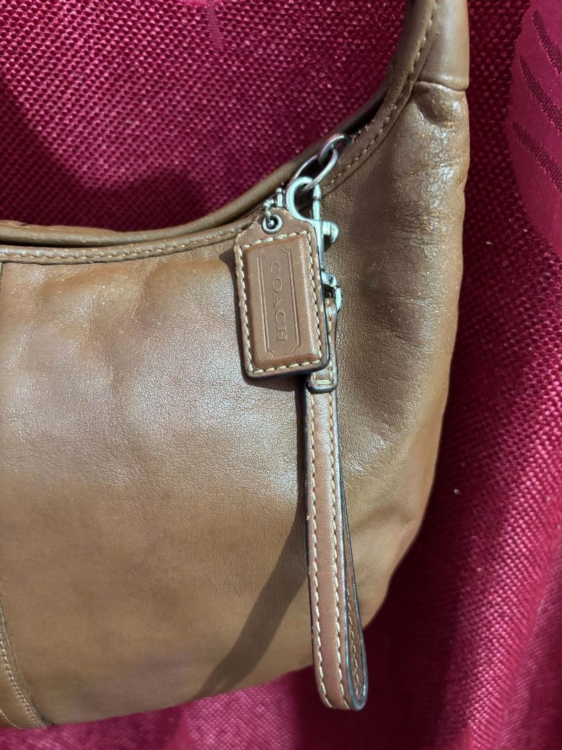 Vintage Coach Ergo Hobo Shoulder Bag (Category: Luxury Bags & Wallets) located in Taguig. Submitted by classicurations (Listing ID 1471024449, Image 3). Description: Authentic brown cowhide leather Coach hobo bag with silver hardware and a soft, slouchy shape. Features a secure zipper closure, matching leather hangtag, and a clean light blue fabric interior with the official creed patch (D0869-F12347)..