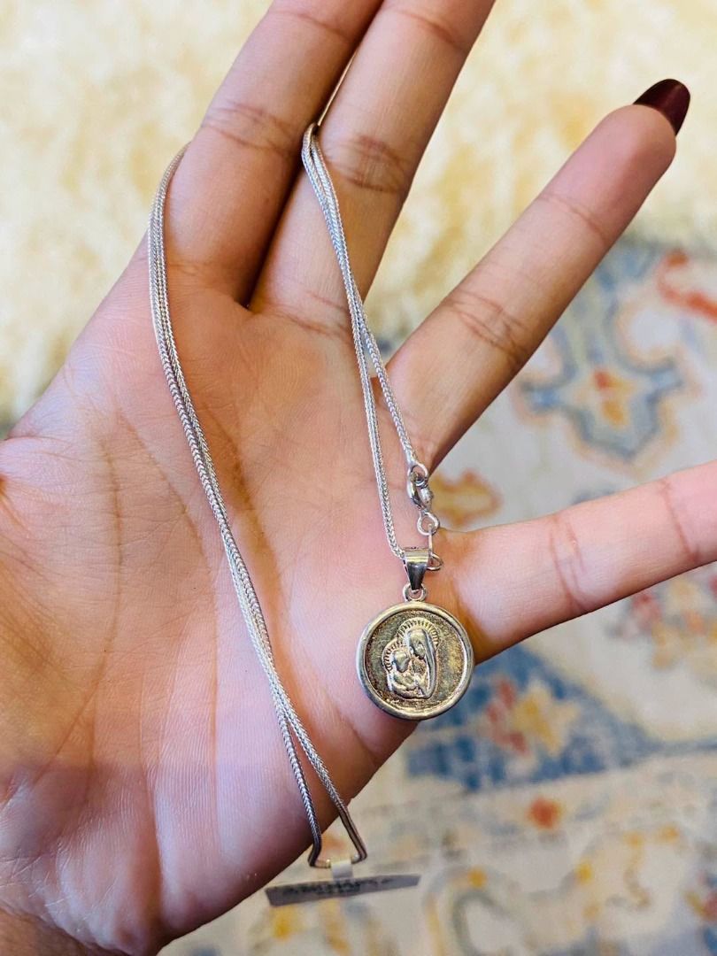 VINTAGE MARY & CHRIST SILVER NECKLACE (Category: Necklaces) located in Baguio. Submitted by asna_taku (Listing ID 1471016416, Image 1). Description: ✨ VINTAGE MARY & CHRIST SILVER NECKLACE ✨ A beautiful vintage religious necklace featuring a detailed medallion of Mother Mary and Baby Jesus, paired with an elegant silver-tone woven chain. A timeless piece symbolizing faith, love, and divine protection. 🤍🙏🏻 ✧ Vintage Piece ✧ Mother Mary & Baby J