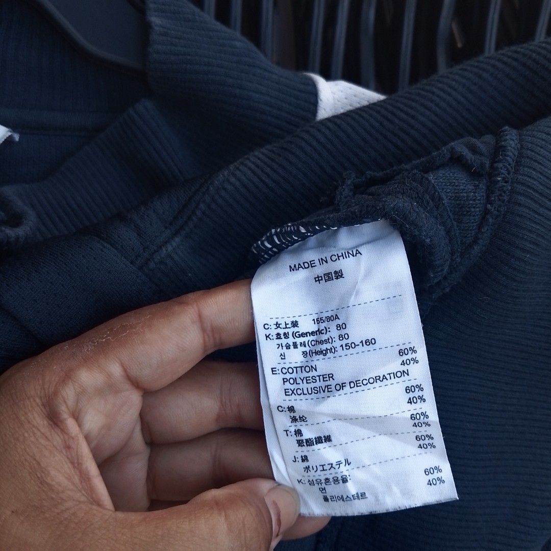 Vintage Nike Button-Up Track Jacket Black Size S (Category: Coats, Jackets and Outerwear) located in Manila. Submitted by jonahq.9 (Listing ID 1471117685, Image 3). Description: - Brand: Nike - Style: Vintage button-up track jacket - Color: Black with white side stripes and embroidered swoosh - Features: Snap button front, collar neck, and two zip pockets - Size: Small (S tag on collar) - Material: 60% cotton, 40% polyester blend - Era: Manufactu