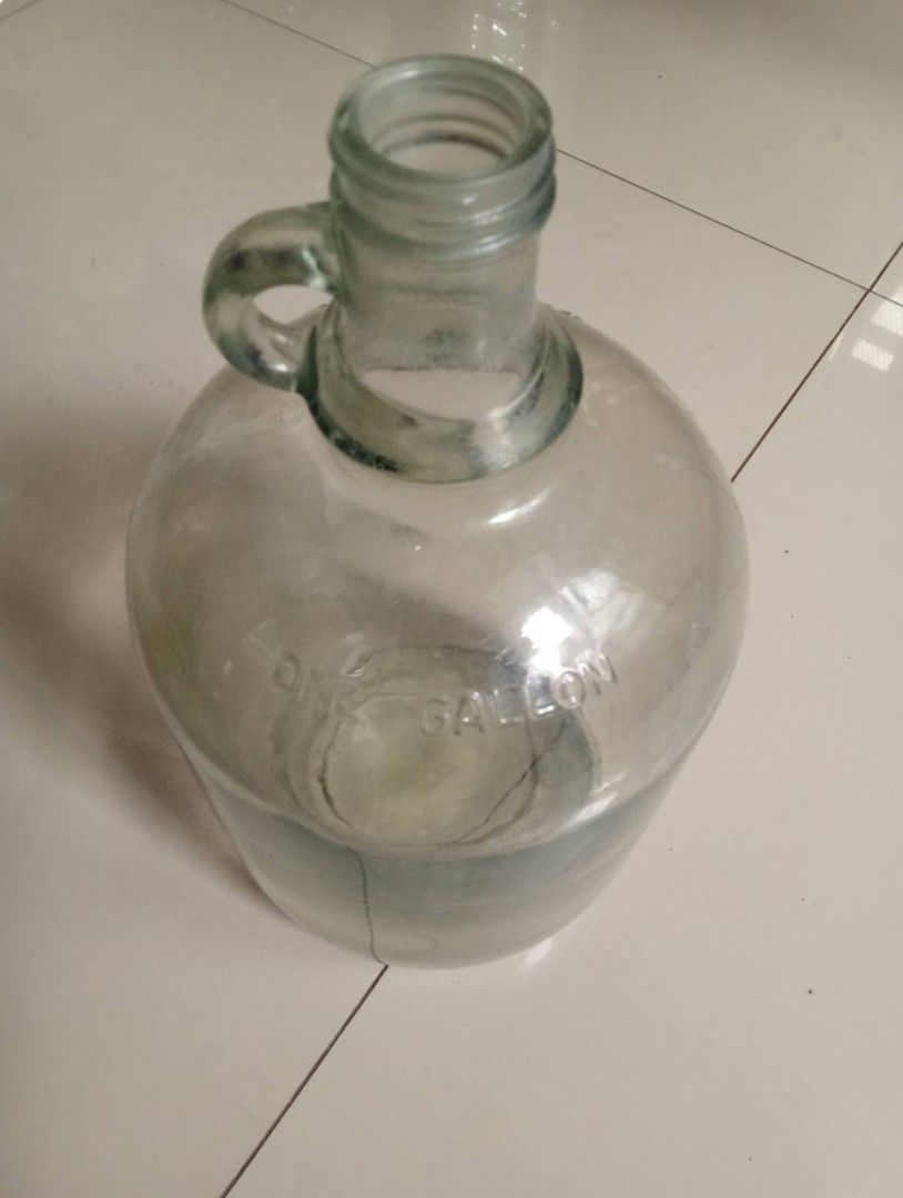 Vintage One-gallon Iridescent Clear Glass Loop Handle Jug, good condition Php900. (Category: Vintage Collectibles) located in Taytay. Submitted by abeatrice77985 (Listing ID 1471027489, Image 2). Description: Vintage One-gallon Iridescent Clear Glass Loop Handle Jug, good condition Php900..