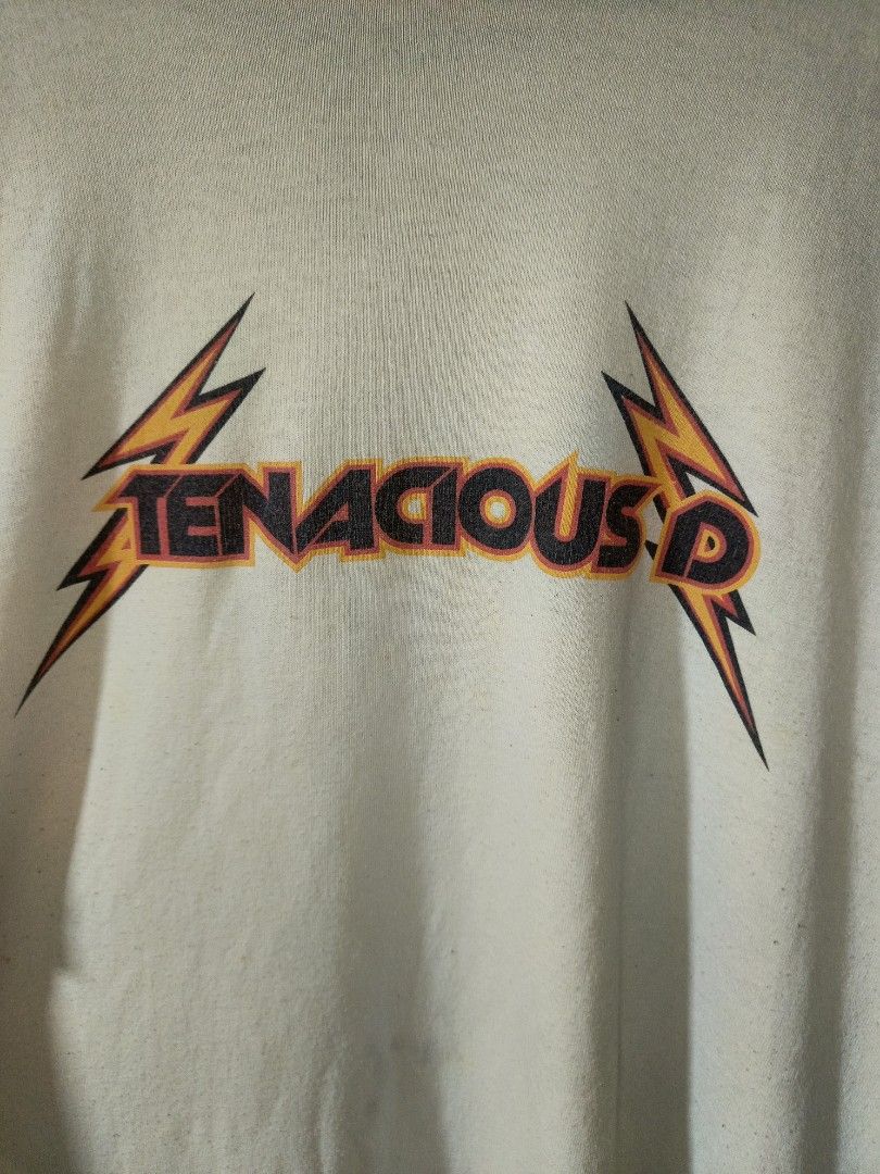 Vintage Soffe 2000s Tenacious D Raglan Baseball Band Tee (Category: Tshirts & Polo Shirts ) located in Santa Rosa. Submitted by animalinstinct.617 (Listing ID 1471047005, Image 2). Description: Authentic Y2K comedy rock merch on a classic Soffe raglan blank. 2XL on Tag. Dimes: W29 * L34.5 Issue: Stains, Lints (Himulmol).