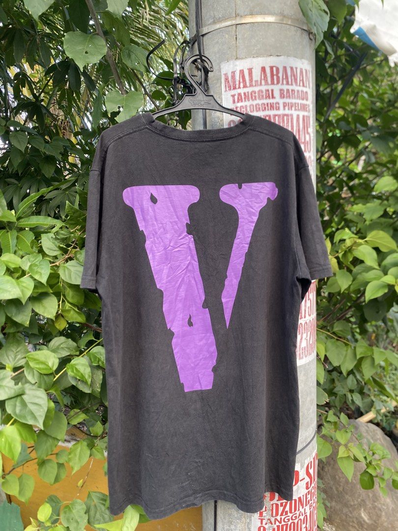 Vlone Black Purple Tee Shirt (Category: Tshirts & Polo Shirts ) located in Lucena. Submitted by puffinthrift (Listing ID 1470988452, Image 2). Description: - Color: Black - Design: Large graphic text on front with signature purple 'V' on the chest, and large purple 'V' print on the back - Fit: Relaxed fit with short sleeves and classic crew neck - Material: Comfortable, high-quality cotton fabric - Style: Versatile streetwear piece, easy to match