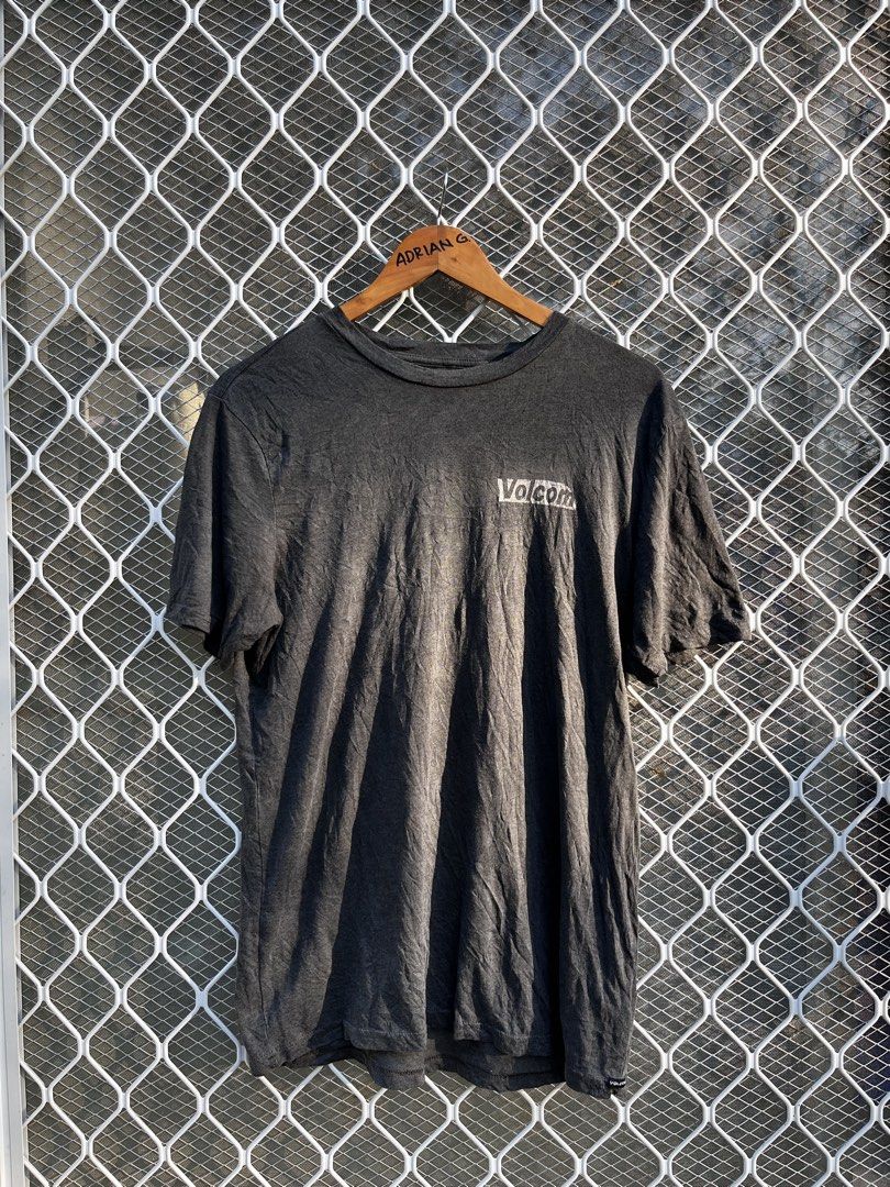 Volcom Grey Modern Fit Graphic Tee Size S (Category: Tshirts & Polo Shirts ) located in Panaon. Submitted by adrian_galope. (Listing ID 1471065918, Image 2). Description: - Brand: Volcom - Color: Dark Grey - Size: Small (S) - Fit: Modern fit - Material: 60% cotton, 40% polyester - Design: Small chest logo and large distressed graphic print on the back - Condition: Pre-loved, well-maintained.