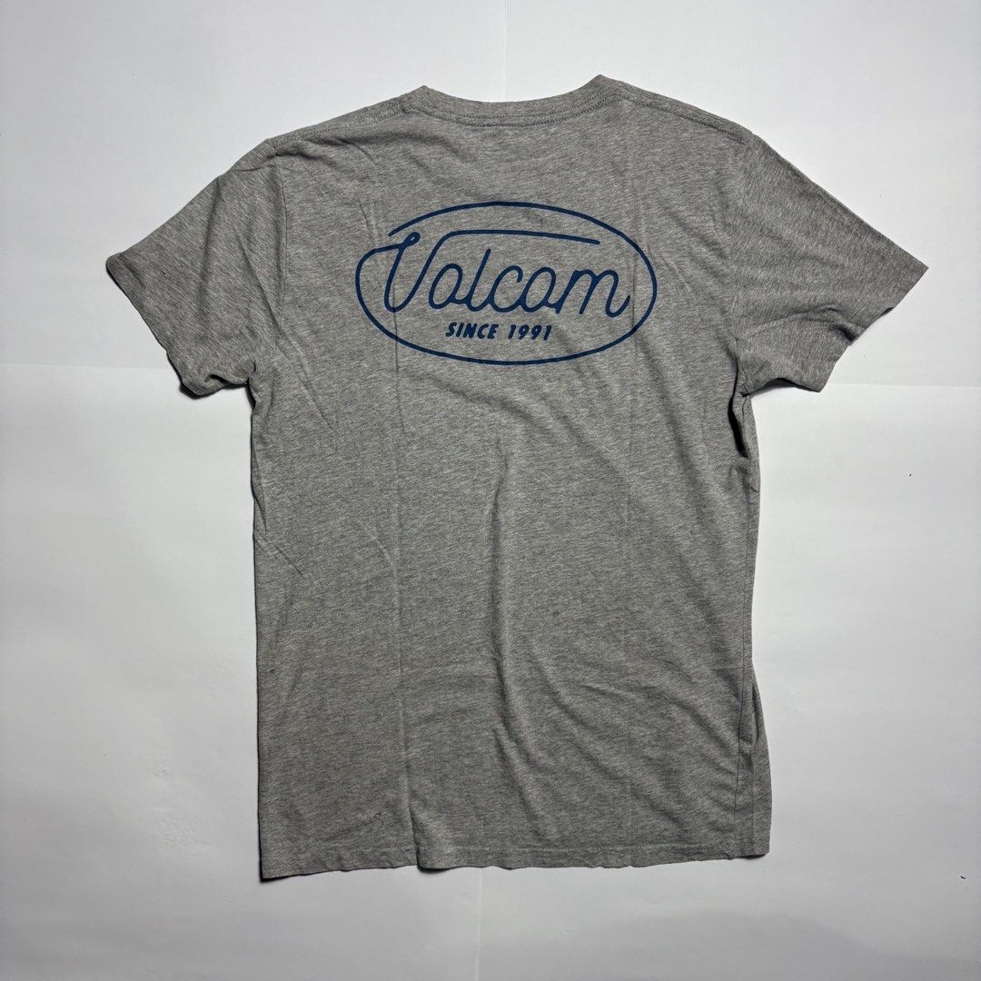 Volcom Heather Grey T-Shirt Size S (Category: Tshirts & Polo Shirts ) located in San Fernando. Submitted by lumang_gamit (Listing ID 1471065750, Image 2). Description: - Brand: Volcom - Size: S/P - Color: Grey - Material: 90% cotton, 10% polyester blend - Design: Small front chest logo and large blue cursive back logo - Neckline: Crew neck with short sleeves - Comfort: Tagless printed inner collar.