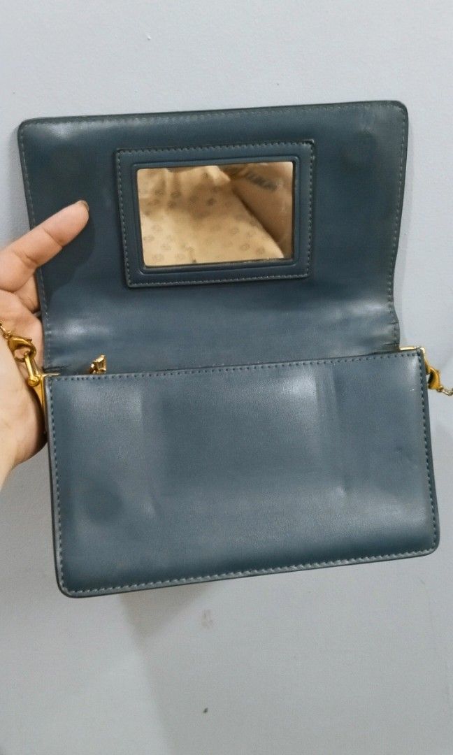 Wallet chain sling bag (Category: Cross-body Bags) located in Trece Martires City. Submitted by vherma (Listing ID 1470948544, Image 2). Description: Color: Dark green, teal, or deep ocean blue Strap: Detachable thin gold-tone metal chain Closure: Magnetic snap flap closure.
