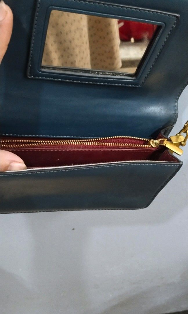 Wallet chain sling bag (Category: Cross-body Bags) located in Trece Martires City. Submitted by vherma (Listing ID 1470948544, Image 3). Description: Color: Dark green, teal, or deep ocean blue Strap: Detachable thin gold-tone metal chain Closure: Magnetic snap flap closure.