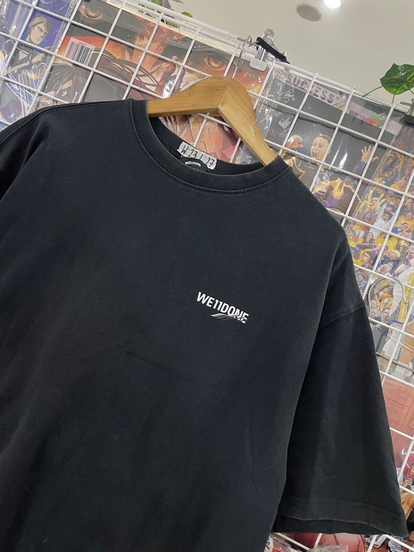 We11done Black T-Shirt (Category: Tshirts & Polo Shirts ) located in Cainta. Submitted by riszizlux (Listing ID 1471035255, Image 1). Description: - Brand: We11done - Color: Black with a faded washed finish - Fit: Relaxed, boxy fit with a classic crew neckline - Details: Small white text logo on the chest - Finishing: Raw hem on sleeves and bottom edge - Condition: Brand new / Excellent.