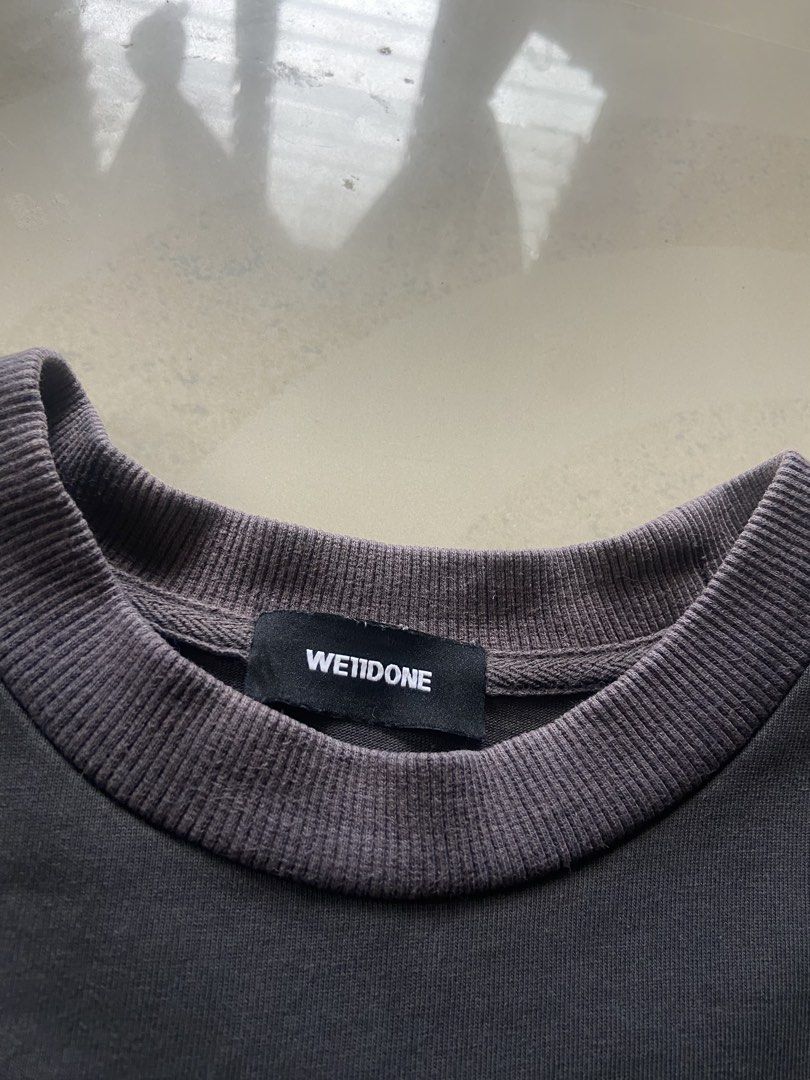 We11done Dark Grey Repeat Logo T-Shirt Size S (Category: Tshirts & Polo Shirts ) located in Manila. Submitted by noblehorse_f6bbe8 (Listing ID 1471062547, Image 2). Description: - Brand: We11done - Color: Washed Dark Grey - Size: S (Relaxed, oversized fit) - Material: Premium heavy cotton jersey - Details: Stacked brand text print on chest, ribbed crewneck, woven brand label on lower back hem - Condition: 100% authentic, well-maintained - Shippin