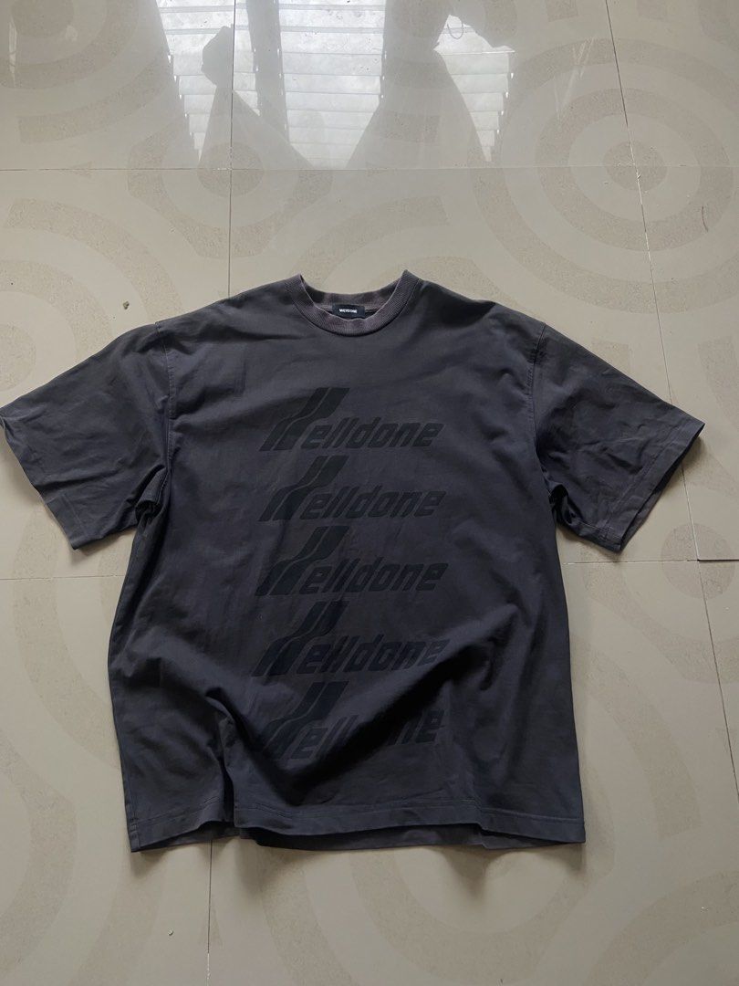 We11done Dark Grey Repeat Logo T-Shirt Size S (Category: Tshirts & Polo Shirts ) located in Manila. Submitted by noblehorse_f6bbe8 (Listing ID 1471062547, Image 1). Description: - Brand: We11done - Color: Washed Dark Grey - Size: S (Relaxed, oversized fit) - Material: Premium heavy cotton jersey - Details: Stacked brand text print on chest, ribbed crewneck, woven brand label on lower back hem - Condition: 100% authentic, well-maintained - Shippin