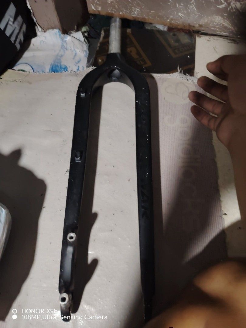 Weapon bike rigid fork black (Category: Bicycles) located in Manila. Submitted by elizer_tiger (Listing ID 1471051433, Image 2). Description: Black rigid bike fork from Weapon. Includes mounting tabs on the left leg and disc brake mounts at the bottom. Standard steerer tube attached at the top. Matte black finish with brand logo embossed on the sides. Some scuffs and signs of wear from previous installation and use. 29er.