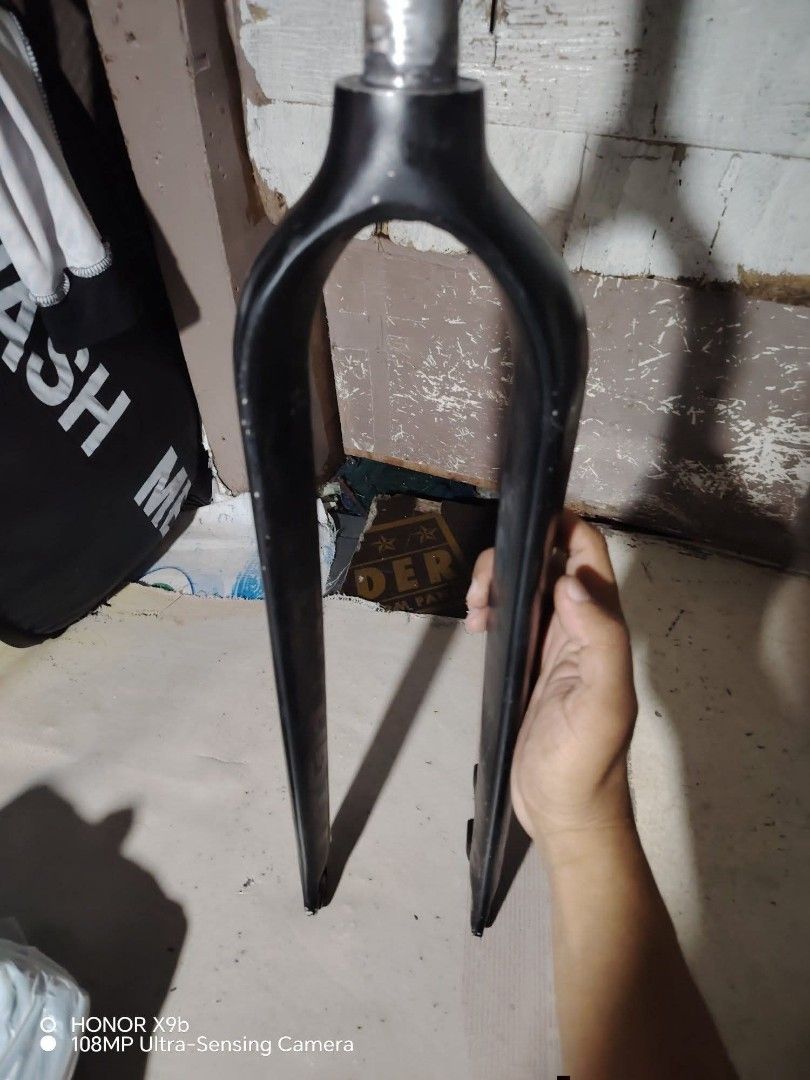 Weapon bike rigid fork black (Category: Bicycles) located in Manila. Submitted by elizer_tiger (Listing ID 1471051433, Image 1). Description: Black rigid bike fork from Weapon. Includes mounting tabs on the left leg and disc brake mounts at the bottom. Standard steerer tube attached at the top. Matte black finish with brand logo embossed on the sides. Some scuffs and signs of wear from previous installation and use. 29er.