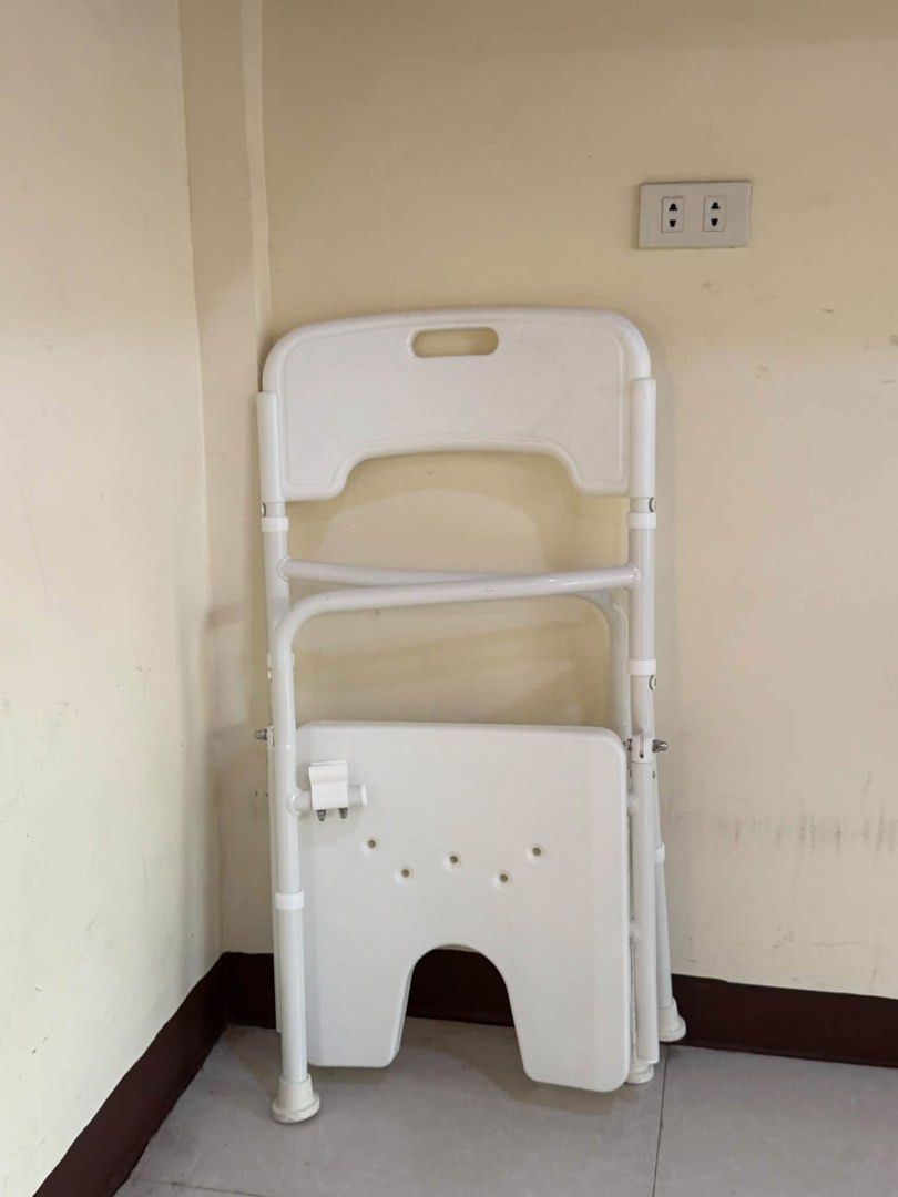 White Adjustable Shower Chair with Backrest and Armrests (Category: Chairs) located in Manila. Submitted by calmdolphin.87b0e4 (Listing ID 1470955642, Image 3). Description: - White shower chair with a sturdy metal frame and adjustable legs - U-shaped cutout seat for easy personal hygiene access - Equipped with comfortable armrests and a supportive backrest with a grab handle - Non-slip rubber tips on all four feet for safety and stability - Fold