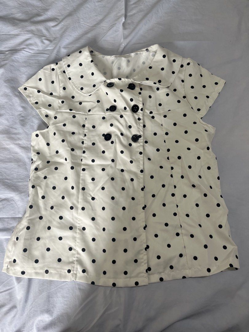 White and Black Polka Dot Double Breasted Blouse (Category: Blouses) located in Manila. Submitted by aaa0ki (Listing ID 1470956444, Image 1). Description: - Color & Pattern: White with all-over black polka dots - Design: Cute Peter Pan collar with a double-breasted black button front - Fit: Paneled construction for a flattering, structured silhouette - Fabric: Lightweight and breathable for all-day comfort - Style: Vintage-inspired retro vibe, pe