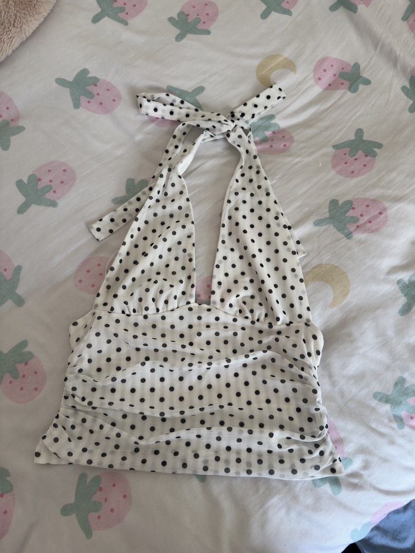 White and Black Polka Dot Halter Top (Category: Sleeveless) located in Manila. Submitted by preloved-bycath (Listing ID 1471078879, Image 1). Description: - Style: White mesh halter top with all-over black polka dots - Fit: Stretchy, form-fitting ruched body with a self-tie neck strap - Design: Cute layered hem detail - Comfort: Super lightweight and breathable fabric - Versatility: Ideal for casual summer days or stylish night outs.