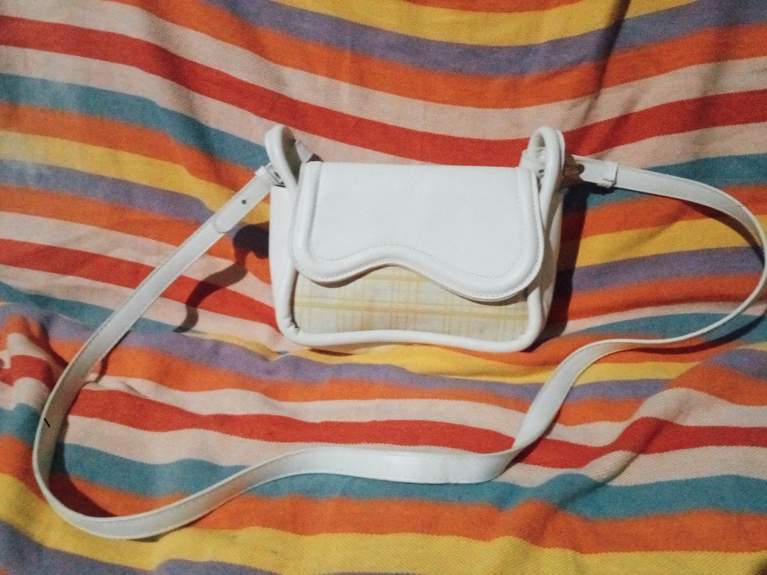 White crossbody bag with plaid front flap and strap (Category: Cross-body Bags) located in Manila. Submitted by littlelove25 (Listing ID 1471096528, Image 1). Description: - Color & Design: Elegant white crossbody bag with a stylish yellow plaid fabric accent - Closure: Secure magnetic snap under the front flap plus a main compartment zipper - Interior: Fully lined to protect your daily essentials - Strap: Comfortable and fully adjustable white s