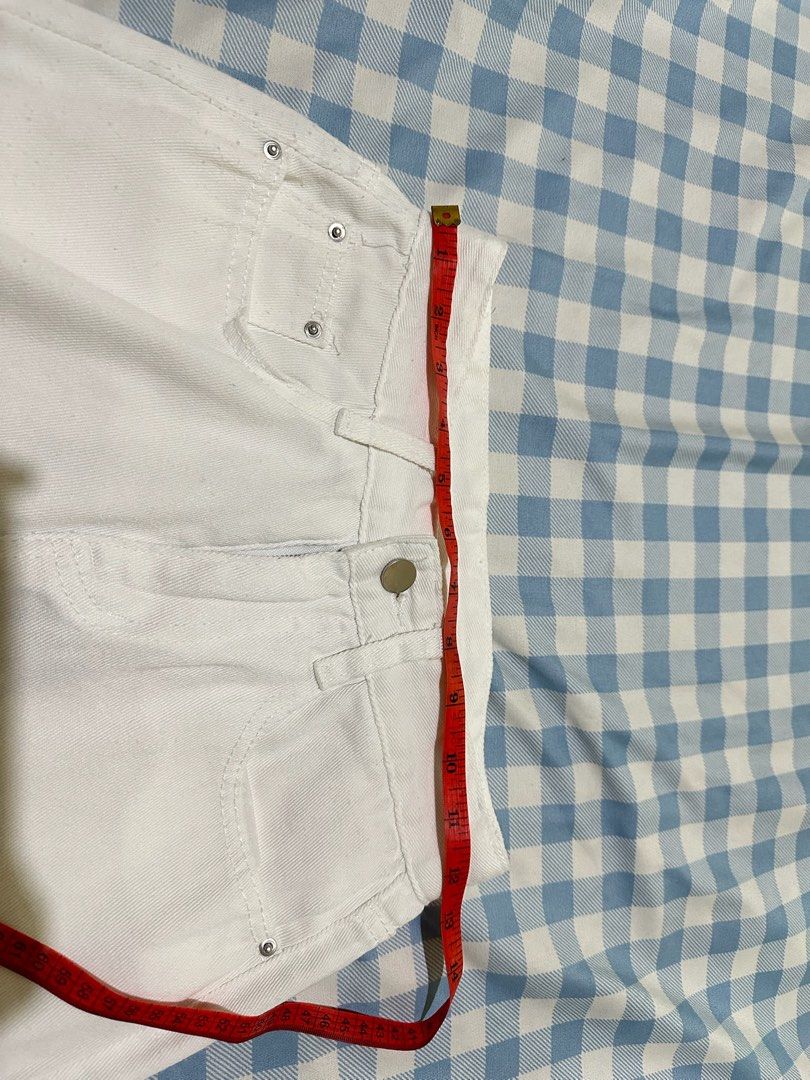 White denim wide leg pants (Category: Jeans) located in Mandaluyong City. Submitted by brightbird-5701 (Listing ID 1471063483, Image 2). Description: - Color: Crisp white - Fit: Straight, relaxed legs with high-rise waist - Closure: Button and zipper - Pockets: Classic five-pocket styling with metal rivets - Measurement: Approx. 14 inches across flat lay waist - Style: Versatile and perfect for casual outfits.