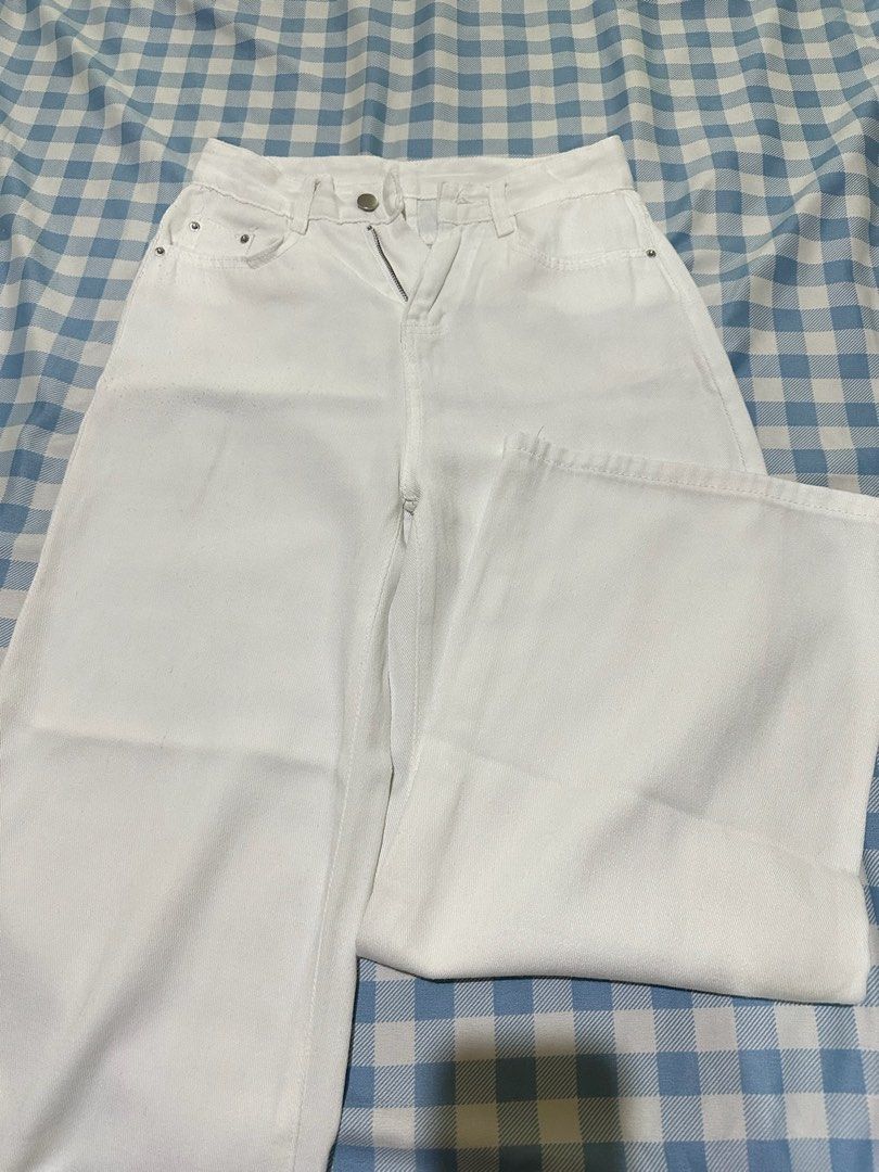 White denim wide leg pants (Category: Jeans) located in Mandaluyong City. Submitted by brightbird-5701 (Listing ID 1471063483, Image 1). Description: - Color: Crisp white - Fit: Straight, relaxed legs with high-rise waist - Closure: Button and zipper - Pockets: Classic five-pocket styling with metal rivets - Measurement: Approx. 14 inches across flat lay waist - Style: Versatile and perfect for casual outfits.