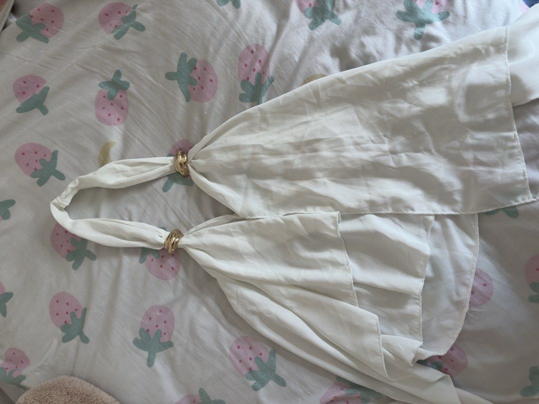 White Halter Top with Gold Ring Detail (Category: Sleeveless) located in Manila. Submitted by preloved-bycath (Listing ID 1471078870, Image 1). Description: - Color: White - Style: Sleeveless halter top with backless design and tie closure - Details: Gold ring accents on straps and layered ruffled hem - Material: Lightweight, flowy fabric - Condition: Clean, no stains or damage - Versatility: Perfect for summer days or night outs, easy to pair wi