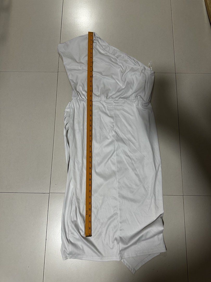 White One Shoulder Asymmetrical Midi Dress (Category: Dresses) located in Quezon City. Submitted by breakstuf50 (Listing ID 1471113333, Image 3). Description: - Style: One-shoulder white midi dress with a chic wrap skirt hem - Fit & Details: Flattering ruched waist, super stretchy and smooth lightweight fabric - Measurements: ~38 inches total length, ~15 inches across the waist (flat) - Occasion: Ideal for parties, date nights, and evening events