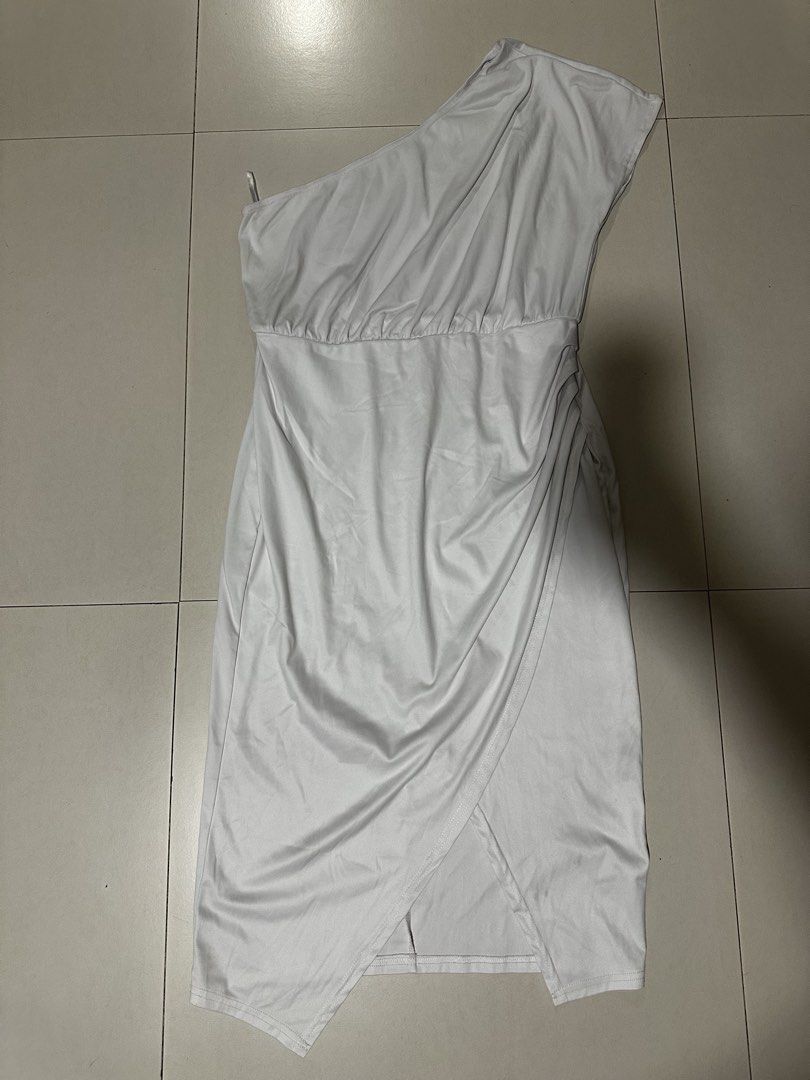 White One Shoulder Asymmetrical Midi Dress (Category: Dresses) located in Quezon City. Submitted by breakstuf50 (Listing ID 1471113333, Image 1). Description: - Style: One-shoulder white midi dress with a chic wrap skirt hem - Fit & Details: Flattering ruched waist, super stretchy and smooth lightweight fabric - Measurements: ~38 inches total length, ~15 inches across the waist (flat) - Occasion: Ideal for parties, date nights, and evening events