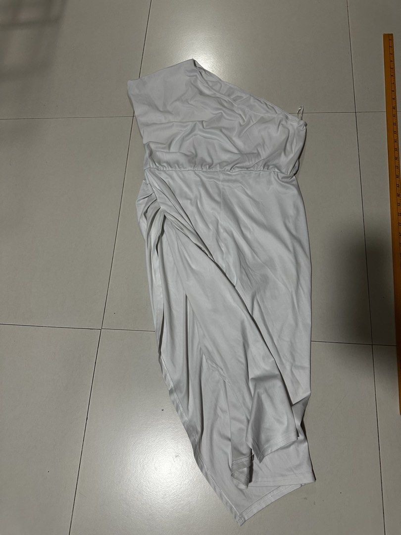 White One Shoulder Asymmetrical Midi Dress (Category: Dresses) located in Quezon City. Submitted by breakstuf50 (Listing ID 1471113333, Image 2). Description: - Style: One-shoulder white midi dress with a chic wrap skirt hem - Fit & Details: Flattering ruched waist, super stretchy and smooth lightweight fabric - Measurements: ~38 inches total length, ~15 inches across the waist (flat) - Occasion: Ideal for parties, date nights, and evening events