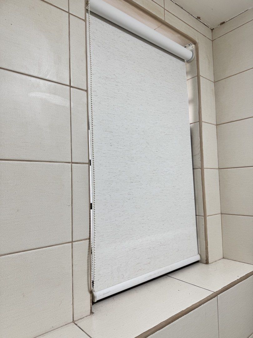 White roller blind window shade with beaded chain (Category: Curtains & Blinds) located in Makati City. Submitted by maria.1024 (Listing ID 1471018220, Image 2). Description: White Textured Roller Window Blind – 21 × 36 Inches Pre-owned roller window blind in a light gray, subtly textured fabric with a clean, minimalist design. Suitable for bathrooms, kitchens, utility rooms, or other small windows. Dimensions: * Width: 21 inches (53 cm) * Height