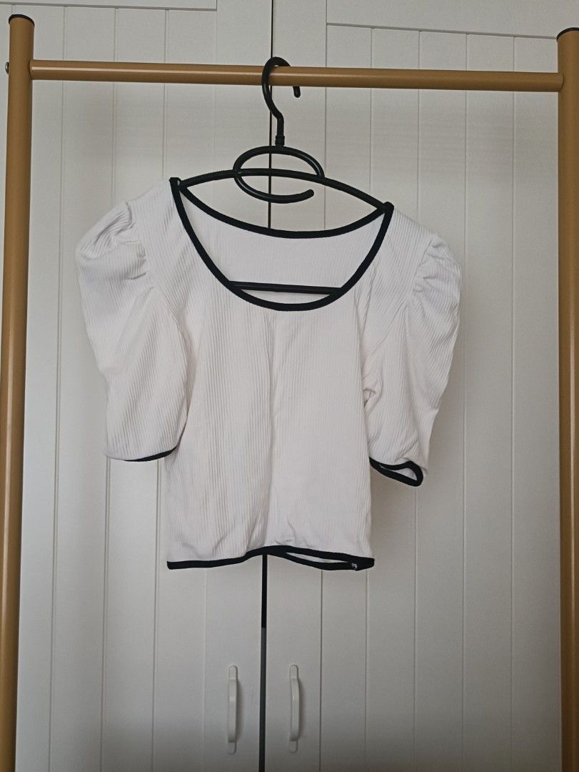 White Square Neck Puff Sleeve Crop Top (Category: Shirts) located in Bacoor. Submitted by Miss_Chuch0521 (Listing ID 1470962804, Image 1). Description: - Brand: No Brand - Style: White ribbed crop top with fitted cut - Details: Square neckline and short puff sleeves with black contrast trim - Fit: Pairs easily with high-waisted jeans - Condition: Clean, modern look ideal for casual outings.