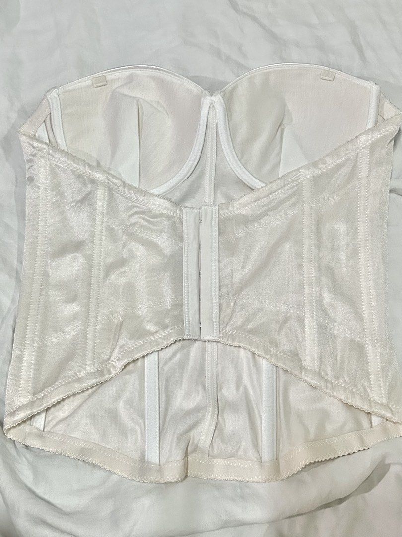 White strapless bustier corset (Category: Sleeveless) located in Muntinlupa City. Submitted by _gudstuff (Listing ID 1471059107, Image 2). Description: - Color: Classic white - Material: Smooth satin-finish fabric with clean lining - Support: Built-in underwire cups and firm internal boning for shaping - Closure: Hook-and-eye closure down the back - Cup size: 85 on tag (38b).