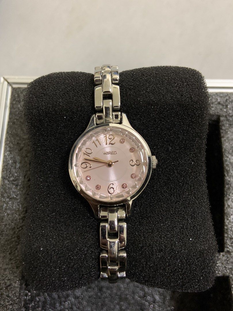 Wired Women's Silver Watch with Pink Dial (Category: Women's Watches) located in Manila. Submitted by relokado (Listing ID 1470938413, Image 1). Description: - Brand: Wired - Gender: Women's - Color: Silver tone with metallic link bracelet - Dial: Round pink dial with crystal markers (odd hours) and Arabic numerals (3, 6, 9, 12) - Hands: Elegant rose gold hands - Condition/Packaging: Comes mounted on a black foam cushion inside a box - Perfect fo