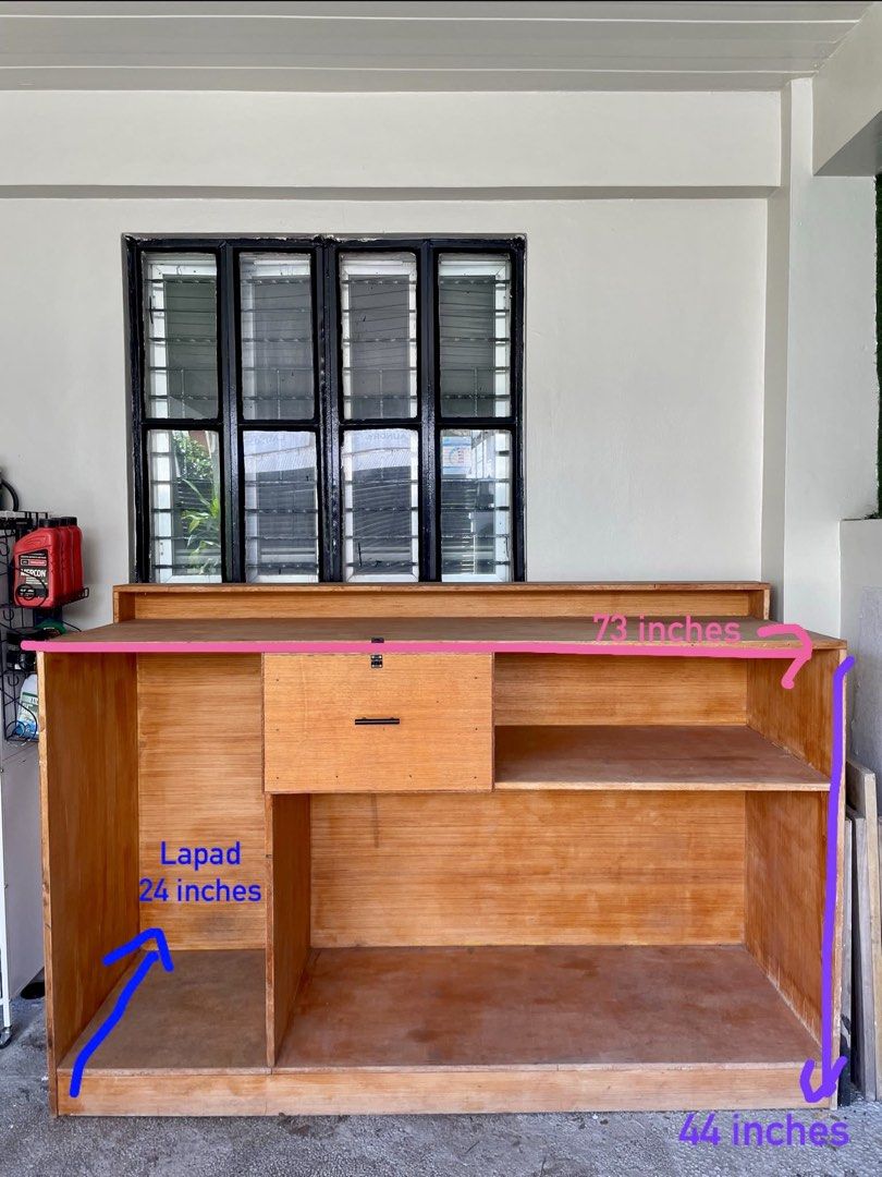 Wooden Coffee Bar Counter Console Table Kitchen Storage (Category: Tables & Sets) located in Muntinlupa City. Submitted by ahermosa (Listing ID 1470960407, Image 2). Description: - Custom wooden coffee bar and kitchen storage counter - Natural wood finish with a sturdy construction. Need re-varnished since naalibukan na at nastock sya sa garage nalang - Dimensions: 73" length x 24" depth x 44" height - Central pull-out drawer equipped with a blac