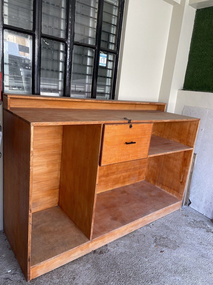 Wooden Coffee Bar Counter Console Table Kitchen Storage (Category: Tables & Sets) located in Muntinlupa City. Submitted by ahermosa (Listing ID 1470960407, Image 3). Description: - Custom wooden coffee bar and kitchen storage counter - Natural wood finish with a sturdy construction. Need re-varnished since naalibukan na at nastock sya sa garage nalang - Dimensions: 73" length x 24" depth x 44" height - Central pull-out drawer equipped with a blac