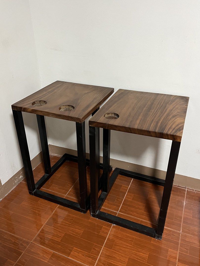 Wooden C-Shaped Side Table Set of Two (Category: Tables & Sets) located in Cabuyao City. Submitted by rdtrmt (Listing ID 1470990529, Image 2). Description: - Set of Two of Wooden C-shaped side table - Made of solid dark wood, natural wood grain top and a black metal frame - Crafted from thick, polished dark wood showing visible grain patterns, featuring built-in circular cup holders or recessed slots near the back edge. - Built with a geometric b