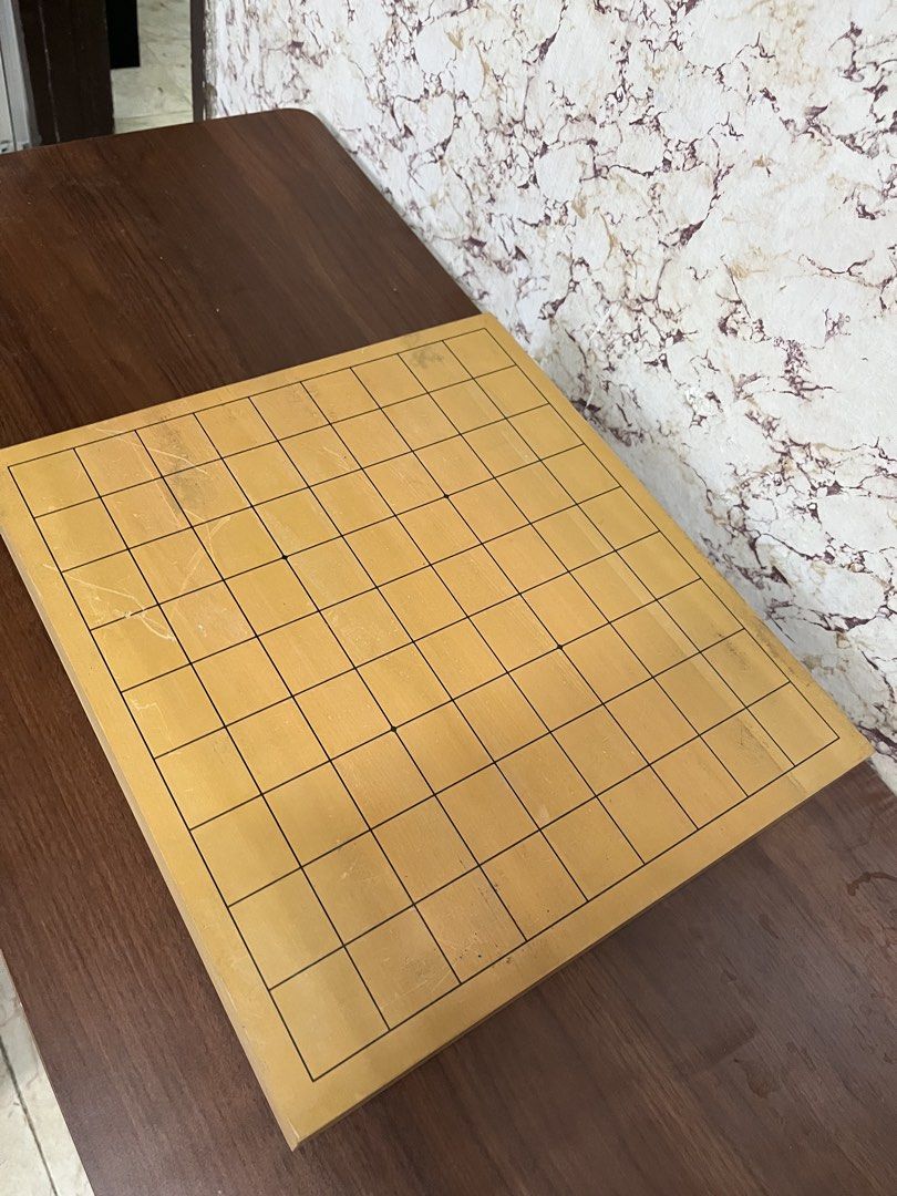 Wooden Go Board Goban Tabletop Strategy Game (Category: Board Games & Puzzles) located in Manila. Submitted by kayerrr.gem (Listing ID 1471049331, Image 2). Description: - Material: Solid wood with standard grid lines - Features: Protective rubber feet to prevent table scratches - Condition: Light surface wear and minor scratches from regular gameplay - Status: Ready for matches.